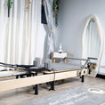 Load image into Gallery viewer, Pilates reformer machine in a room with curtains and decor